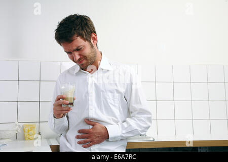 young man,coffee time,abdominal pain Stock Photo