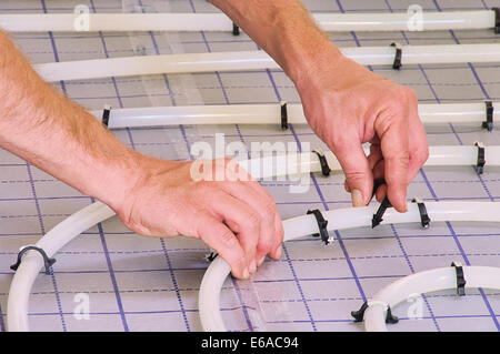 floor heating,laying tile Stock Photo