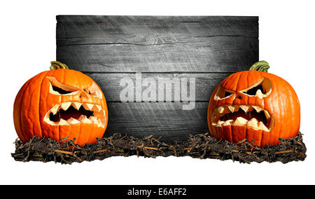 Halloween sign with two scary pumpkins in front of an old blank weathred wood banner as a concept for a creepy advertisement and marketing announcement for a harvest time party. Stock Photo