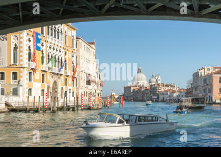 A water taxi passing under the Accademia Bridge on the Grand Canal in Venice. Stock Photo