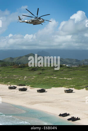 A U.S. Marine Corps CH-53E Super Stallion helicopter flies over a simulated amphibious beach assault during Rim of the Pacific (RIMPAC) 2014 at Marine Corps Base Hawaii July 29, 2014. RIMPAC is a U.S. Pacific Fleet-hosted biennial multinational maritime e Stock Photo