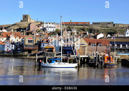 Whitby harbor showing boats on either side and loads of people crab ...