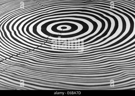 full frame abstract picture showing a piece of wood with black and white painted annual rings Stock Photo