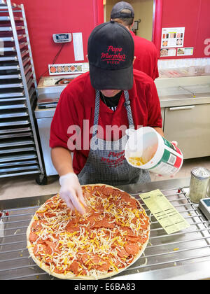 Female Employee Prepares a Pizza, Small Business, pizzeria, USA Stock Photo