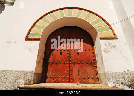 Bolivia, Copacabana, low angle view of an arch entrance with nailed closed door. Stock Photo