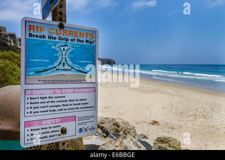 USA, California, Dana Point. A sign warns of strong rip currents in the Pacific Ocean off the coast of California. Stock Photo