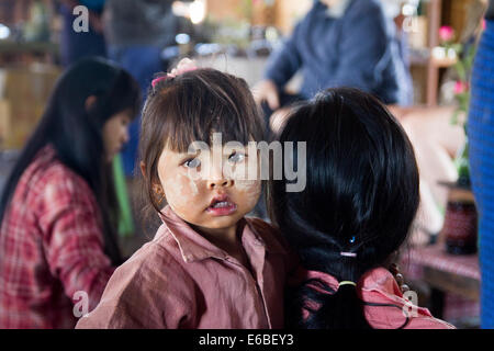 Child with mother at cheroot factory, Inle Lake, Shan State, Myanmar. Photo © Nile Sprague Stock Photo