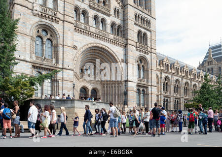 Visitors queuing outside the main entrance to the Natural History Museum London Stock Photo