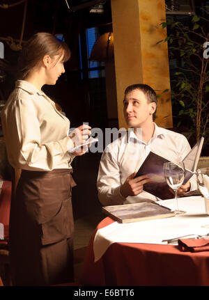 Waiter taking order from restaurant customer Stock Photo