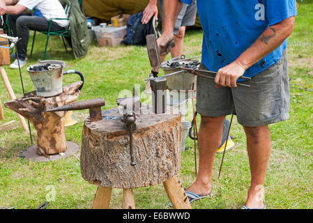 Close up of blacksmith man person working metal at Driffield Show East Yorkshire England UK United Kingdom GB Great Britain Stock Photo
