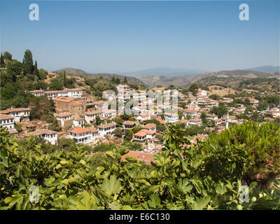 view over  the turkish village of sirince in izmir province with fig tree in foreground Stock Photo