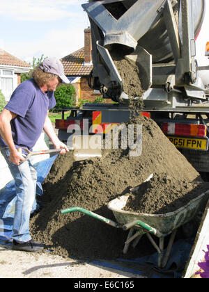 Lorry delivering concrete & cement for use in a home extension Stock Photo