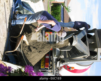 Lorry delivering concrete & cement for use in a home extension Stock Photo