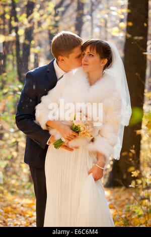 Beautiful Bride and groom together in park -rain Stock Photo
