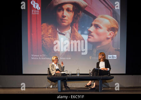 London, England, UK, 19 August 2014. Legendary BAFTA-Award winning multi-camera television drama director Moira Armstrong (L) being interviewed by Francine Stock (R) at an event in Miss Armstrong's honour organised by the British Film Institute (BFI) in association with BAFTA and Women in Film & Television (WFTV). The background slide is a still from Moira Armstrong’s 1979 BBC production ‘Testament of Youth’, an adaptation of Vera Brittain’s classic memoir about the impact of World War I. Credit:  John Henshall / Alamy Live News PER0421 Stock Photo