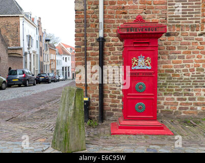 traditional red mailbox with the official weapon of the kingdom of the Netherlands on it Stock Photo