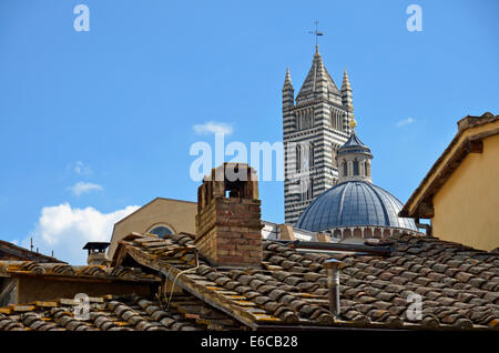 Siena, Tuscany, Italy, Europe - Bell tower of the Duomo di Siena cathedral across red rooftops Stock Photo