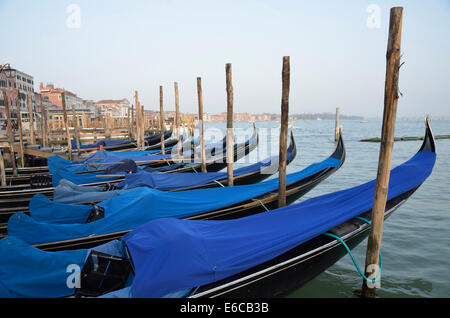 Row of empty moored gondolas, Venice, Italy, Europe in the early morning light Stock Photo