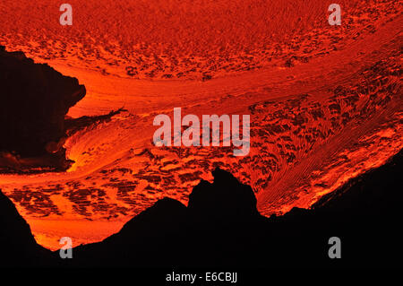 River of molten lava flowing to the sea at sunrise, Kilauea Volcano, Big Island, Hawaii Islands, USA Stock Photo