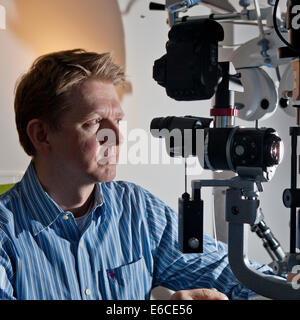 Portrait of doctor with equipment used for Laser (Lasik) eye surgery. Stock Photo