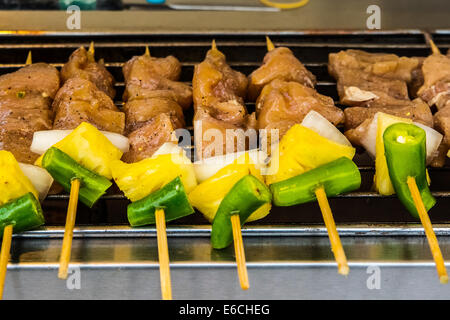 chicken satay skewer., asian food in the night market, thai style barbecue with meat and vegetables. Stock Photo