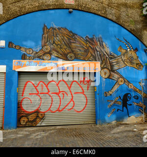 City Bike Service with leaping goats graffiti art in Shoreditch, London Stock Photo