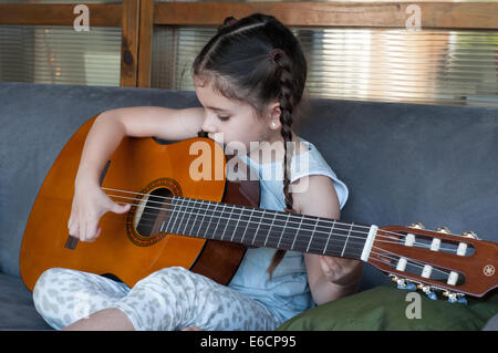 Child playing guitar Stock Photo