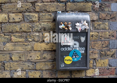 Overfilled rubbish bin sponsored by Addison Lee Stock Photo