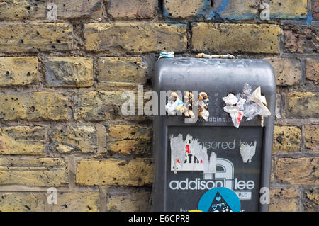 Overfilled rubbish bin sponsored by Addison Lee Stock Photo