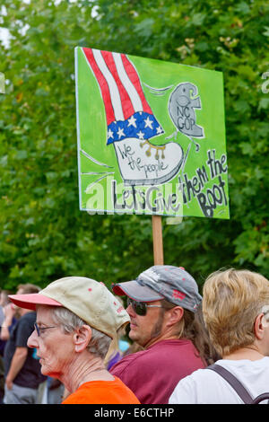 Asheville, North Carolina, USA - August 4, 2014:  Man holds a sign saying to boot out the Republicans at a Moral Monday rally Stock Photo