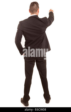 A young man with his back turned to camera, pointing to something Stock Photo