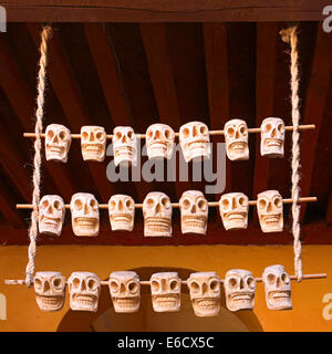 Wooden skulls during Day of the Dead ceremonies hang from the ceiling of a  store in Patzcuaro, Michoacan, Mexico. Stock Photo