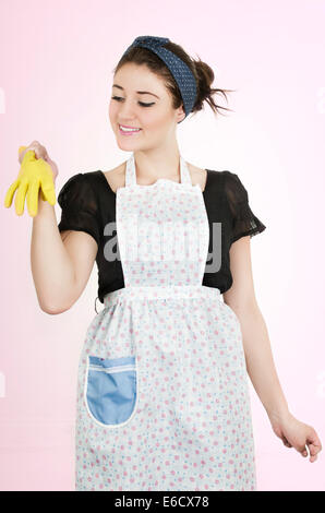 Young beautiful hispanic maid wearing apron and gloves Stock Photo