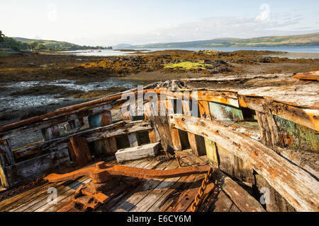 An old fishing boat run aground at Salen on the Isle of Mull, Scotland, UK. Stock Photo