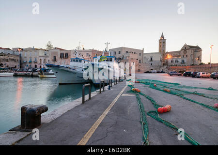 Fishing nets laid out to dry in the harbor, behind the Romanesque Cathedral of Trani 11th century, Trani, Apulia province, Italy Stock Photo