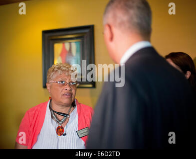 Ferguson, Mo. 20th Aug, 2014. United States Attorney General Eric Holder, right, listens to Viola Murphy, Mayor of Cool Valley, Mo., before his meeting with local community leaders at Drake's Place Restaurant, Wednesday, Aug. 20, 2014 in Ferguson, Mo. Holder traveled to the St. Louis-area to oversee the federal government's investigation into the shooting of 18-year-old Michael Brown by a police officer on Aug. 9th. Credit:  dpa picture alliance/Alamy Live News Stock Photo