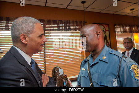 Ferguson, Mo. 20th Aug, 2014. United States Attorney General Eric Holder, left, speaks with Capt. Ron Johnson, right, of the Missouri State Highway Patrol at Drake's Place Restaurant, Wednesday, Aug. 20, 2014, in Ferguson, Mo. Holder arrived in Missouri on Wednesday, as a small group of protesters gathered outside the building where a grand jury could begin hearing evidence to determine whether a Ferguson police officer who shot 18-year-old Michael Brown should be charged in his death. Credit:  dpa picture alliance/Alamy Live News Stock Photo