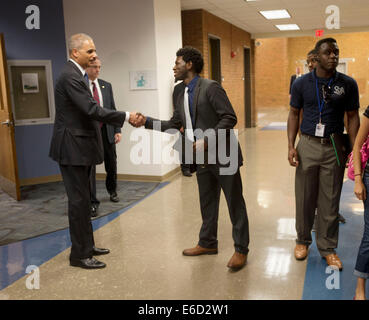 Ferguson, Mo. 20th Aug, 2014. United States Attorney General Eric Holder, left, shakes hands with Bradley J. Rayford, 22, right, following his meeting at St. Louis Community College Florissant Valley, Wednesday, Aug. 20, 2014 in Ferguson, Mo. Holder traveled to the St. Louis-Area to oversea the federal government's investigation into the shooting of 18-year-old Michael Brown by a police officer on Aug. 9th. Holder promised a 'fair and thorough' investigation into the fatal shooting of a young black man, Michael Brown Credit:  dpa picture alliance/Alamy Live News Stock Photo