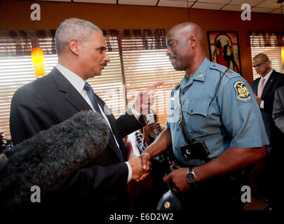 Ferguson, Mo. 20th Aug, 2014. United States Attorney General Eric Holder, left, talks with Capt. Ron Johnson, right, of the Missouri State Highway Patrol at Drake's Place Restaurant, Wednesday, Aug. 20, 2014 in Florrissant, Mo. Holder traveled to the St. Louis-Area to oversee the federal government's investigation into the shooting of 18-year-old Michael Brown by a police officer on Aug. 9th. Holder promised a 'fair and thorough' investigation into the fatal shooting of a young black man, Michael Brown Credit:  dpa picture alliance/Alamy Live News Stock Photo