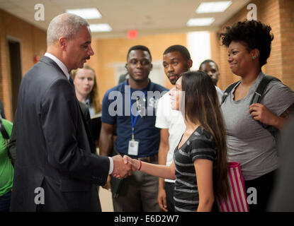 Ferguson, Mo. 20th Aug, 2014. United States Attorney General Eric Holder, left, shakes hands with Bri Ehsan, 25, right, following his meeting with students at St. Louis Community College Florissant Valley, Wednesday, Aug. 20, 2014 in Ferguson, Mo. Holder traveled to the St. Louis-Area to oversea the federal government's investigation into the shooting of 18-year-old Michael Brown by a police officer on Aug. 9th. Holder promised a 'fair and thorough' investigation into the fatal shooting of Michael Brown Credit:  dpa picture alliance/Alamy Live News Stock Photo