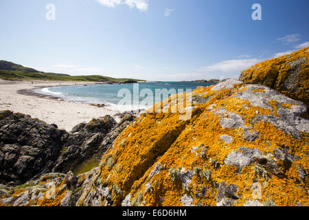 Aquamarine seas and lichen covered rock on the West coast of Iona, off Mull, Scotland, UK. Stock Photo