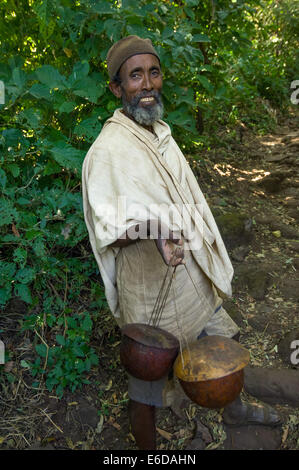 Monk carrying honey pots to the Daga Estifanos (St. Michael's of Daga) monastery, Daga Island, Ethiopia Stock Photo