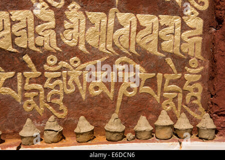 Eastern Bhutan, Mongar, Yadi village, tiny clay Buddhist chortens beside mani wall mantra Stock Photo