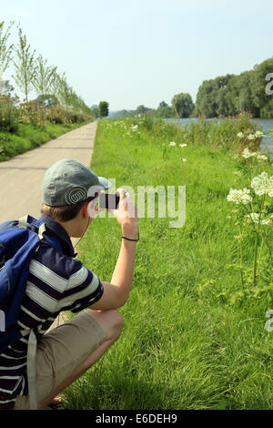 15 year old teenage boy taking a photograph of Canal Maritime de Abbeville a St Valery, Boismont, St Valery sur Somme, picardy Stock Photo