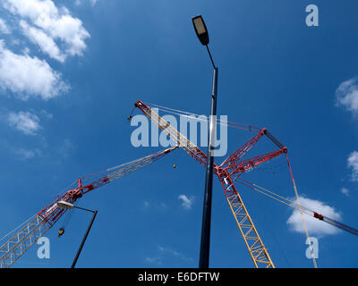 Construction cranes with street lights UK Stock Photo