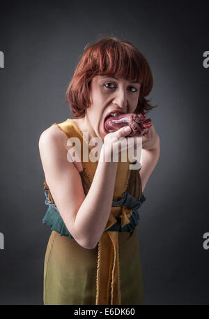 woman eating a heart. Based on sonnet 'A ciascun alma presa' of Dante Alighieri Stock Photo