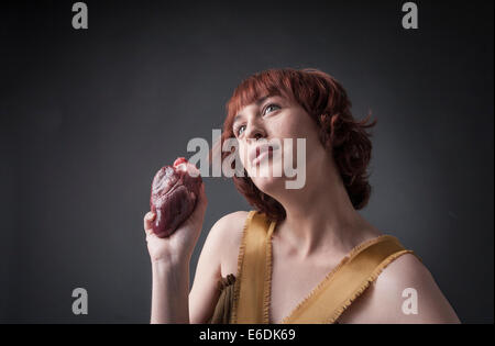 Woman with heart in her hand. Based on sonnet 'A ciascun alma presa' of Dante Alighieri Stock Photo