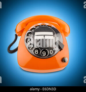 an old orange phone with rotary dial Stock Photo