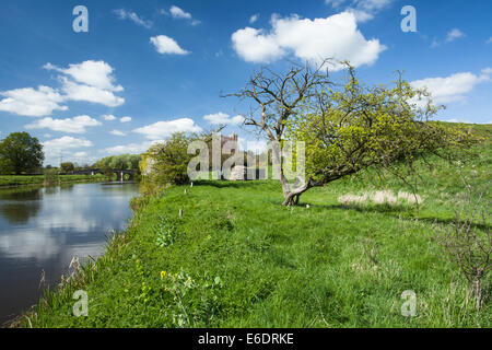 Beside the River Nene and all that remains of the former motte & bailey castle at Fotheringhay in east Northamptonshire, England Stock Photo