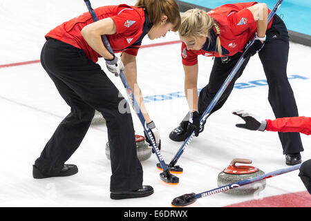 Claire Hamilton and Anna Sloan (R) of Team Great Britain sweep during  Women's curling competition at the Olympic Winter Games, Stock Photo